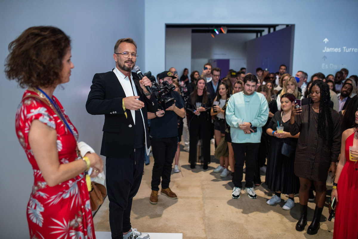 Mollie Dent Brocklehurst and Mikoaj Sekutowicz opening remarks at Secret Soire Photo World Red Eye 